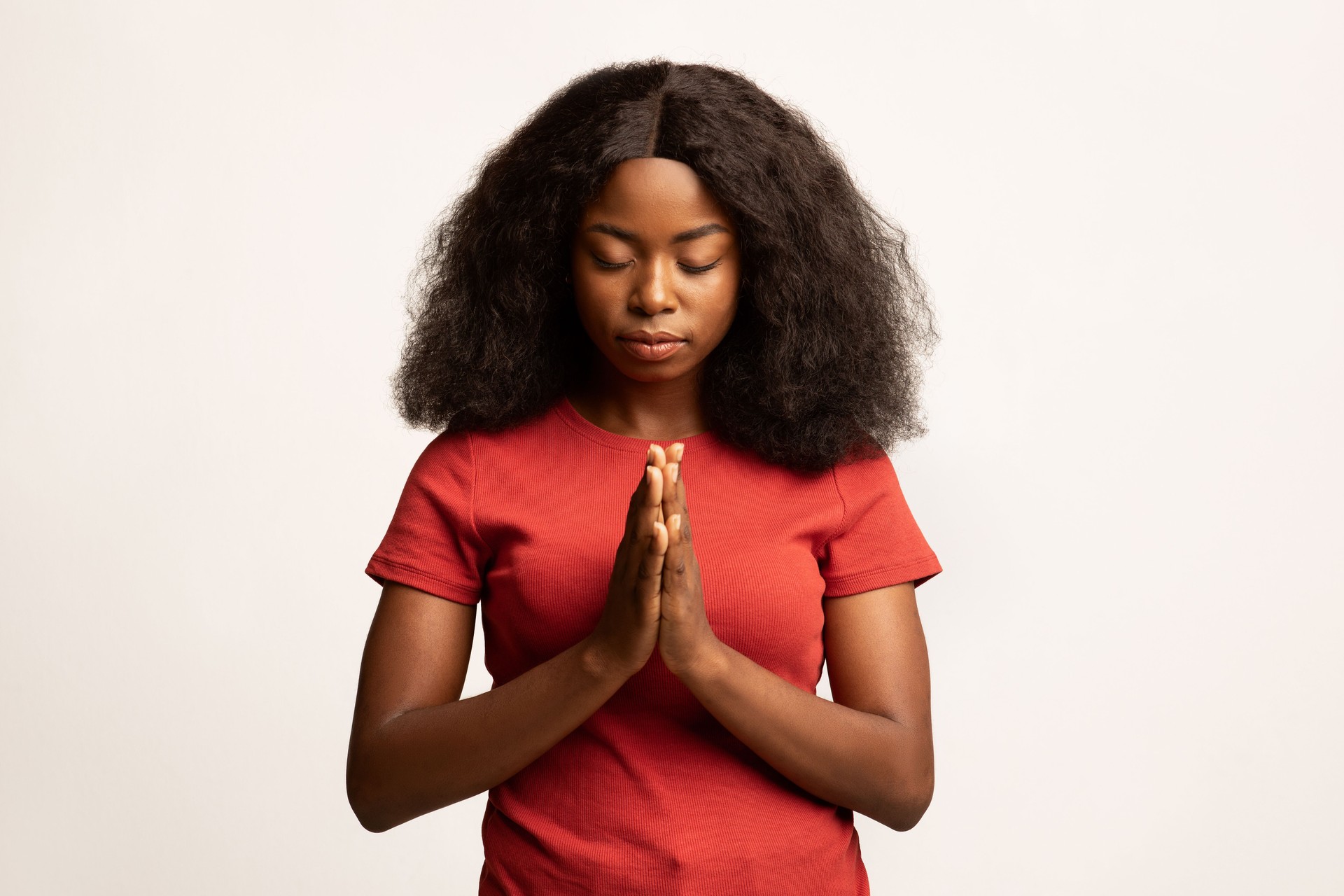 Faith Concept. Calm African American Female Praying With Clasped Hands