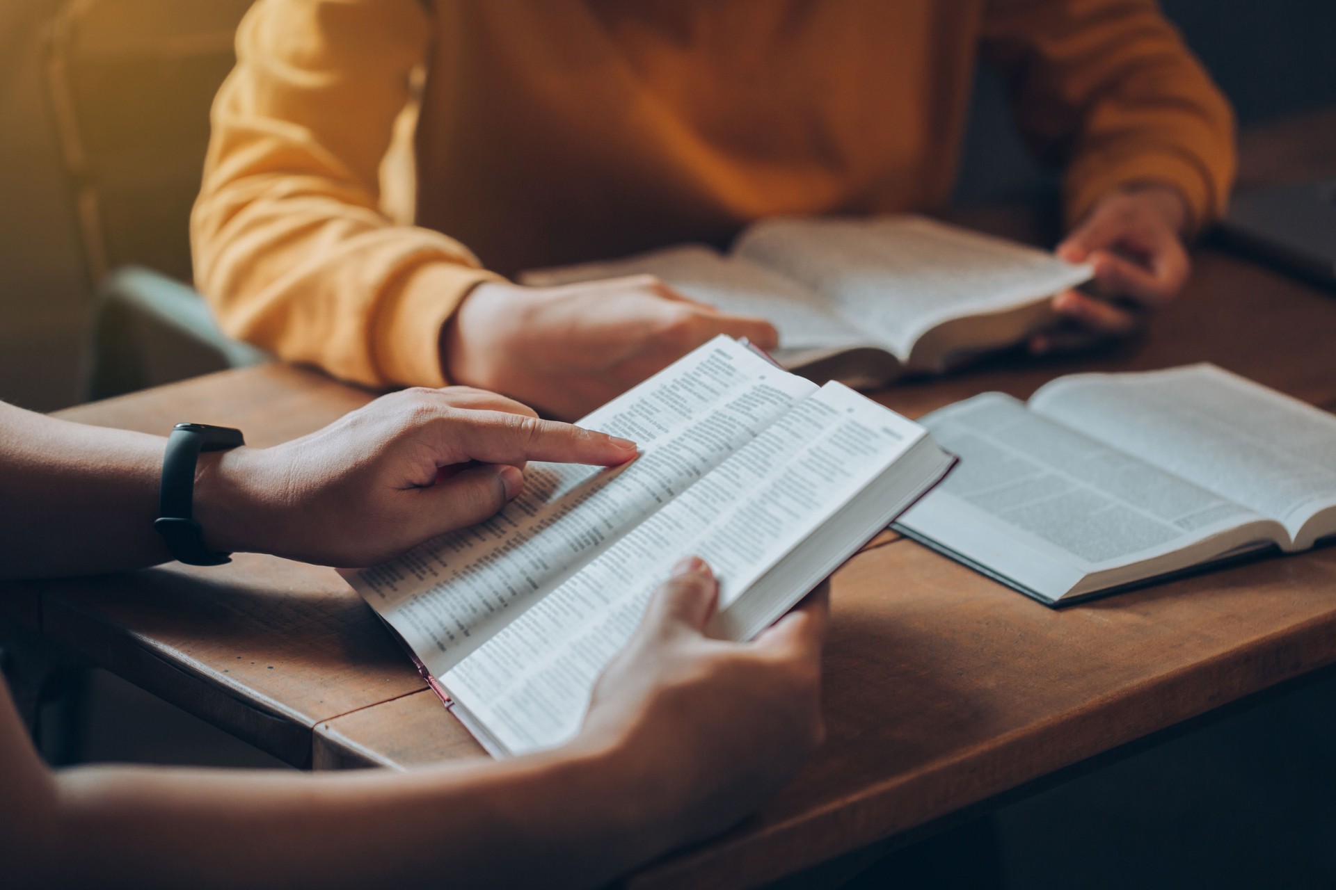 Christian Bible Study Concepts. Christian friend's groups read and study the bible together in a home with window light. followers are studying the word of God in churches.